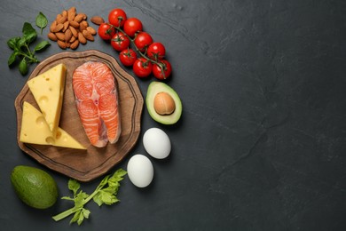 Photo of Flat lay composition with keto diet products on black table, space for text