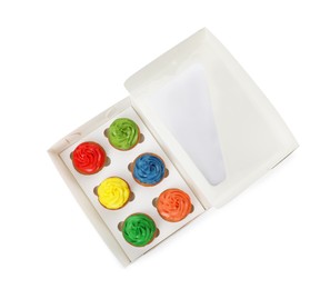 Photo of Box with delicious colorful cupcakes isolated on white, top view
