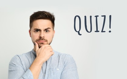 Image of Thoughtful man and word QUIZ on white background 