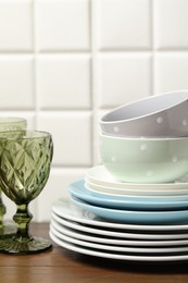Photo of Beautiful ceramic dishware and glass on wooden table