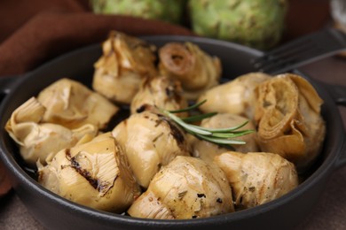 Photo of Delicious pickled artichokes with rosemary in bowl, closeup