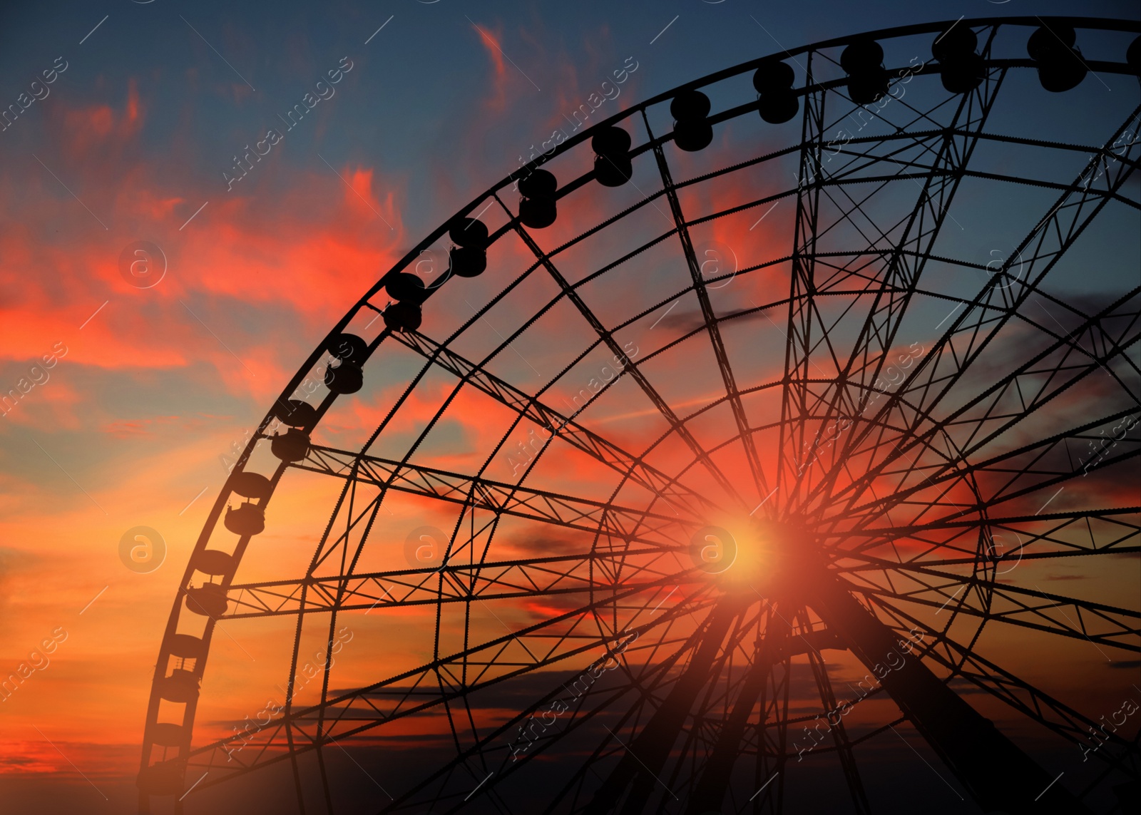 Beautiful large Ferris wheel outdoors at sunset, low angle view Image of Beautiful large Ferris wheel outdoors at sunset, low angle view