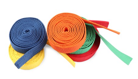 Photo of Many different karate belts isolated on white, above view