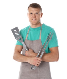 Photo of Man in apron with barbecue utensils on white background