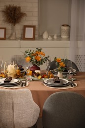 Photo of Table set with beautiful autumn decor for festive dinner in room