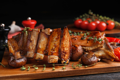 Photo of Delicious roasted ribs served on table, closeup