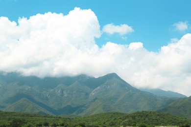 Photo of Picturesque view of mountains and green meadow