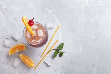 Photo of Glass of tasty refreshing cocktail on marble table, flat lay. Space for text