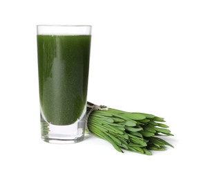 Photo of Wheat grass drink in shot glass and fresh green sprouts isolated on white