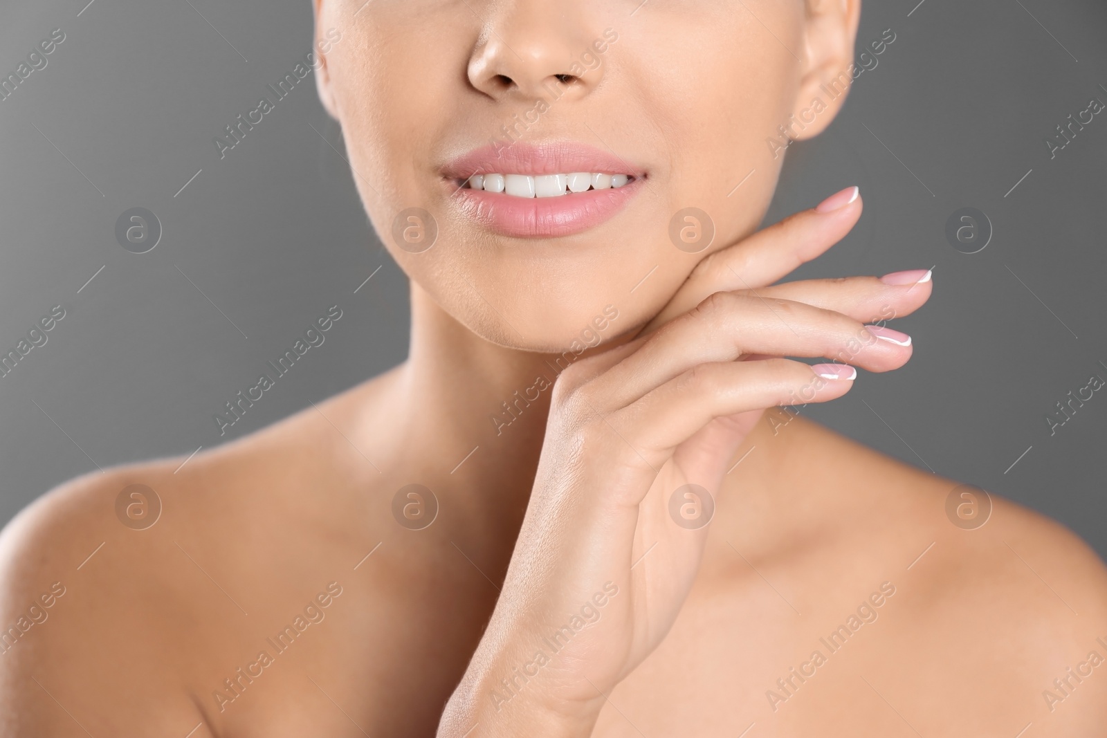 Photo of Closeup view of beautiful young woman on grey background. Lips contouring, skin care and cosmetic surgery concept