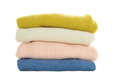 Photo of Stack of different warm sweaters isolated on white
