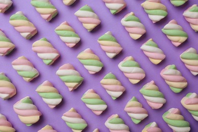 Photo of Delicious colorful marshmallows on violet background, flat lay