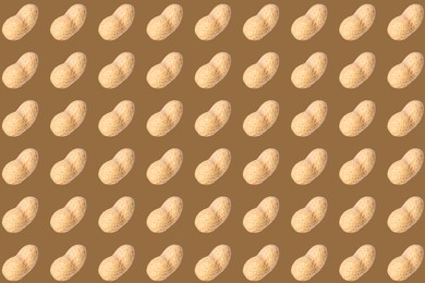 Image of Pattern of unpeeled peanuts on brown background