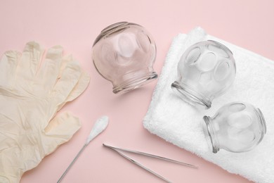 Photo of Flat lay composition with glass cups on pink background. Cupping therapy