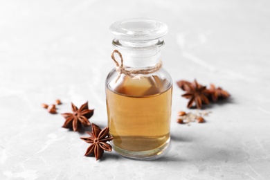 Photo of Anise essential oil and spice on light table