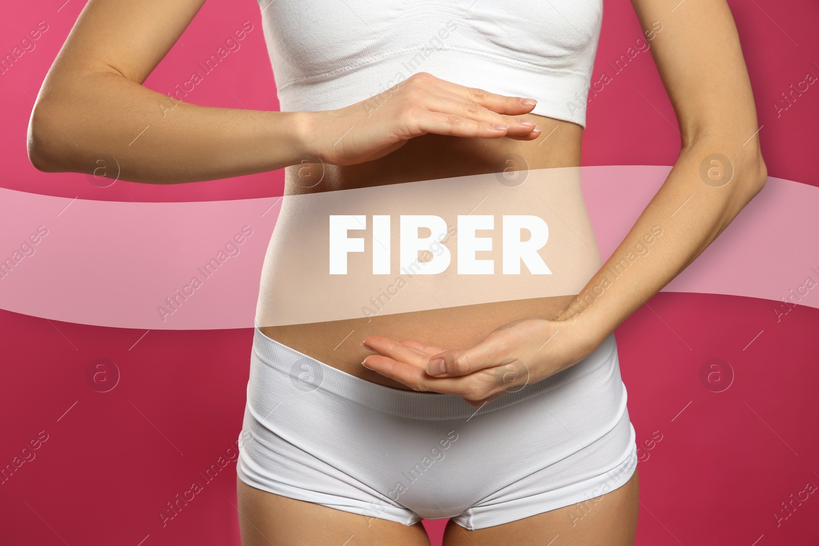 Image of Woman holding hands near belly and word Fiber, closeup