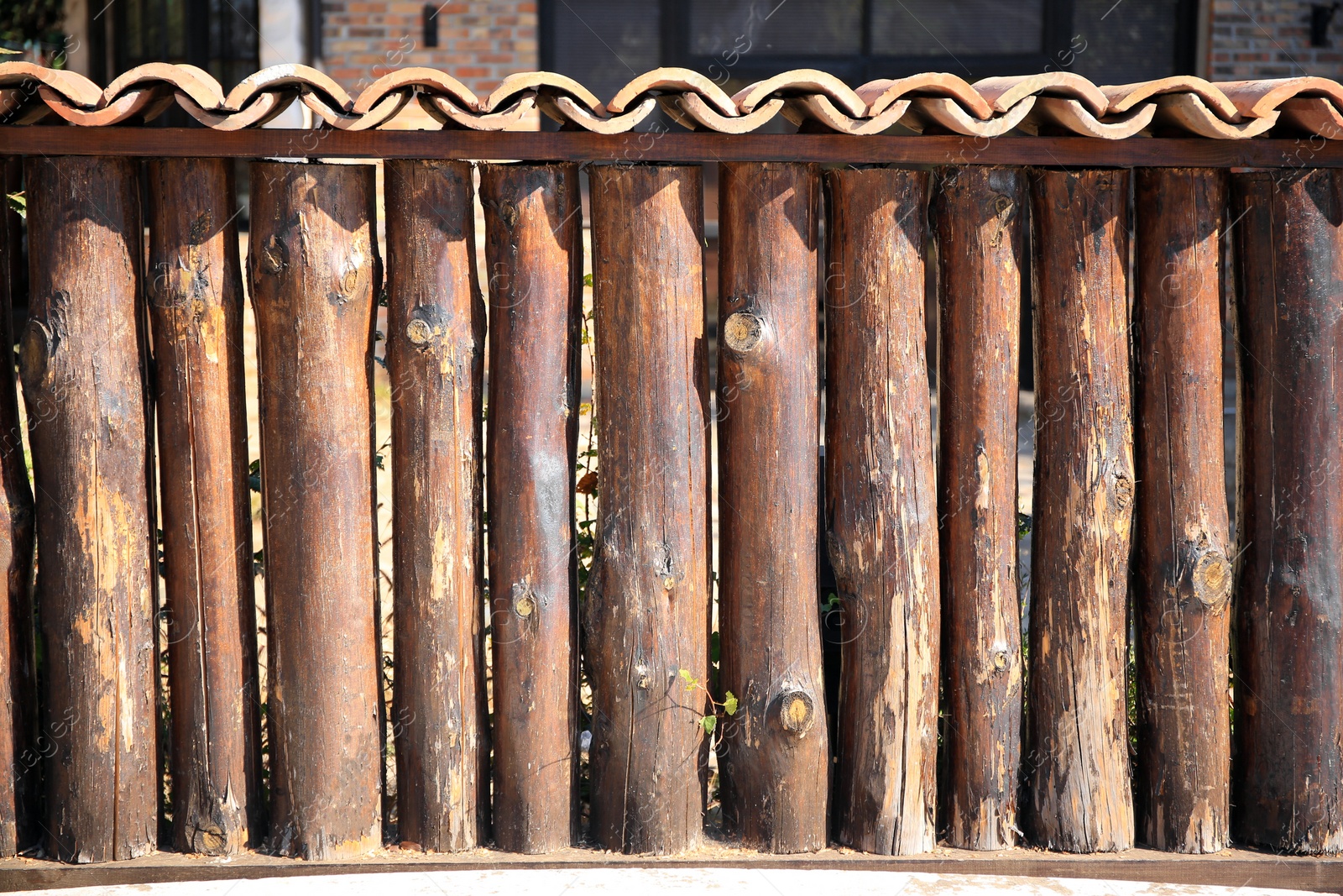 Photo of Brown wooden fence outdoors on sunny day