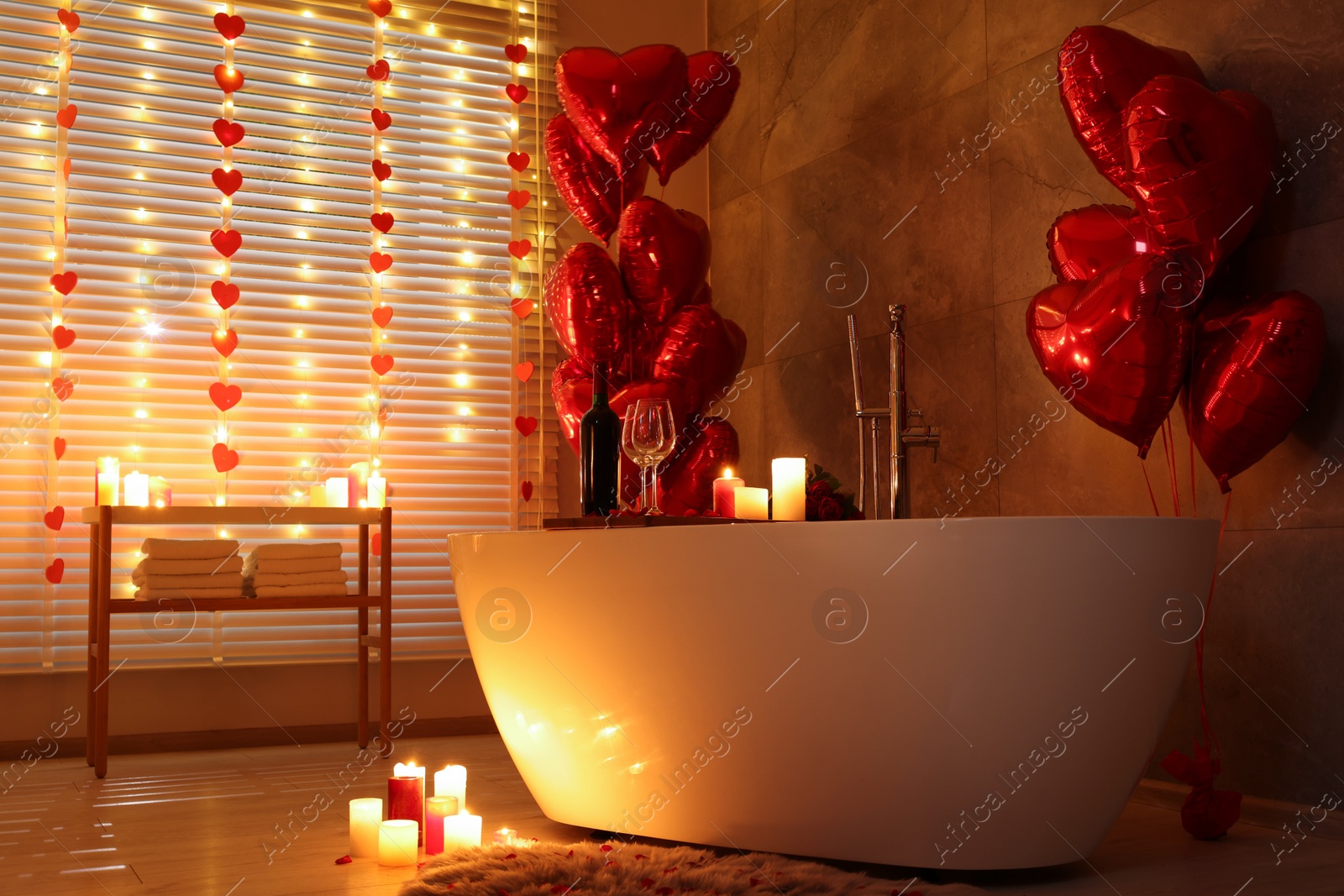 Photo of Stylish bathroom decorated for Valentine's day. Interior design