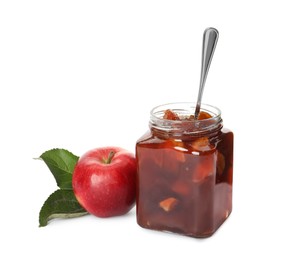 Tasty apple jam and spoon in glass jar near fresh fruit on white background