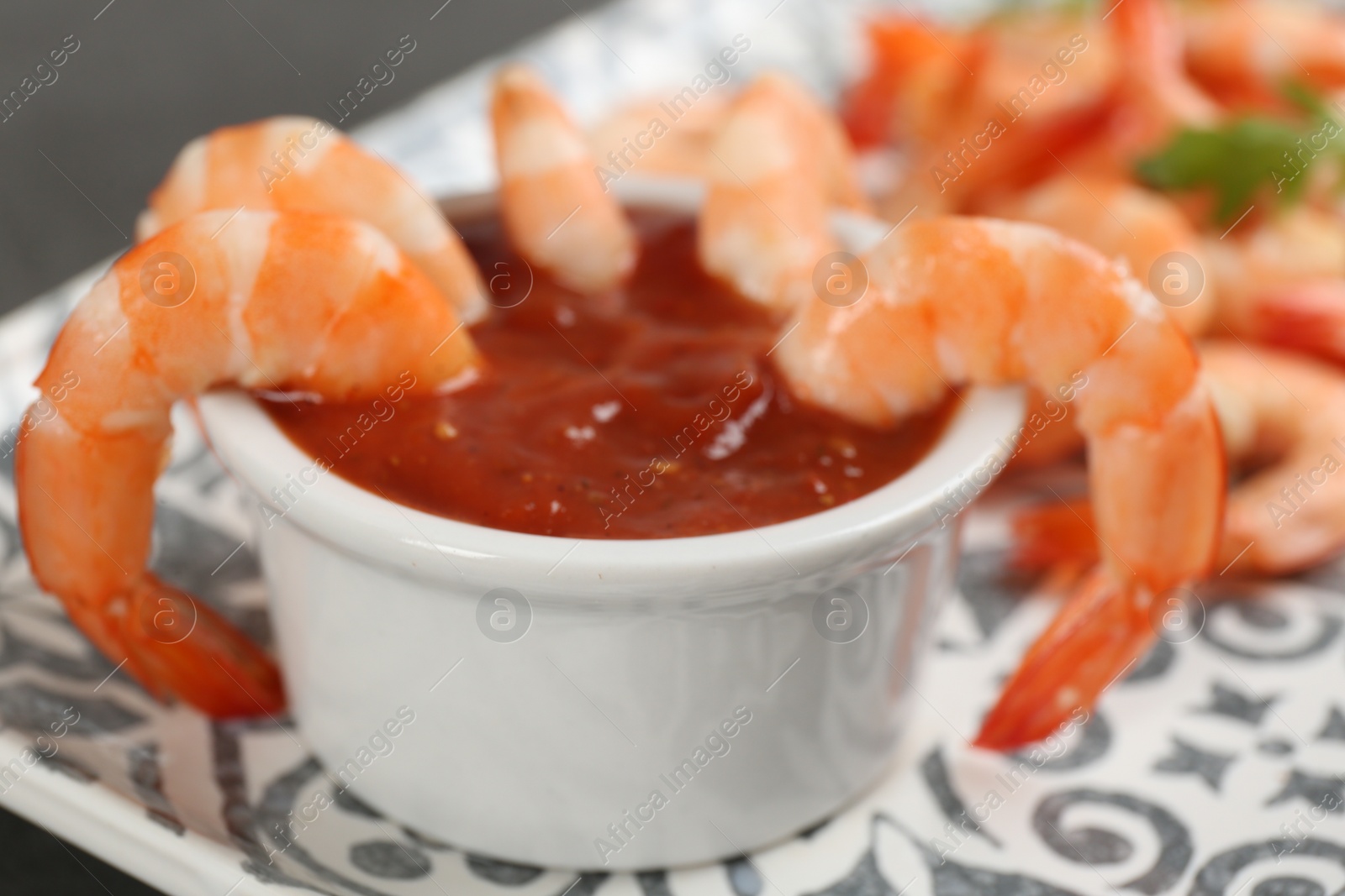 Photo of Delicious shrimp cocktail with tomato sauce, closeup