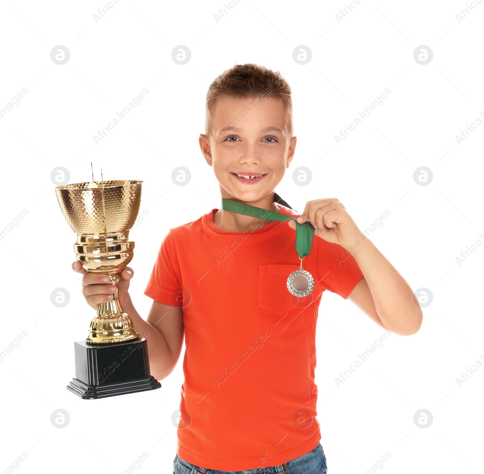 Photo of Happy boy with golden winning cup and medal isolated on white