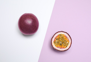 Photo of Fresh ripe passion fruits (maracuyas) on color background, flat lay