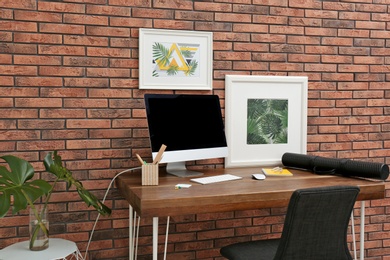 Photo of Interior of stylish workplace with modern computer at home