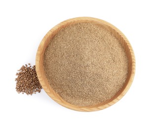 Wooden bowl with powdered coriander and corns on white background, top view