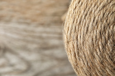 Photo of Spool with hemp rope on blurred background, closeup. Space for text