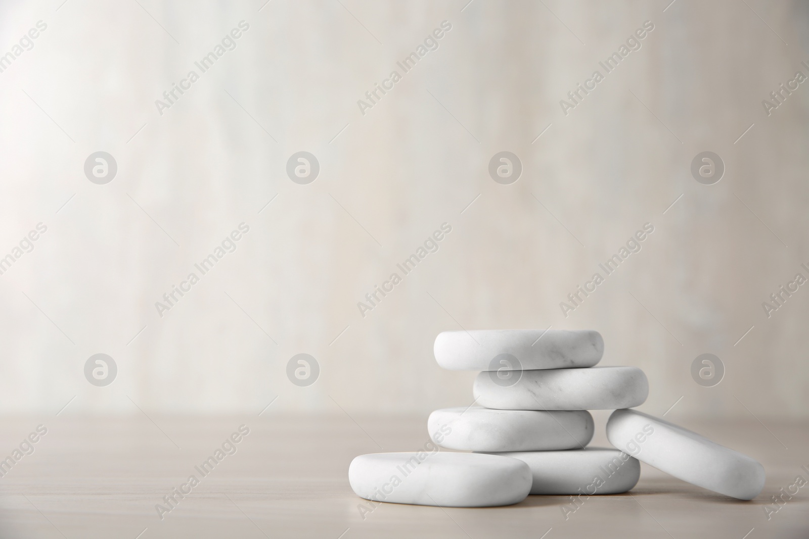 Photo of Marble spa stones on light background. Space for text