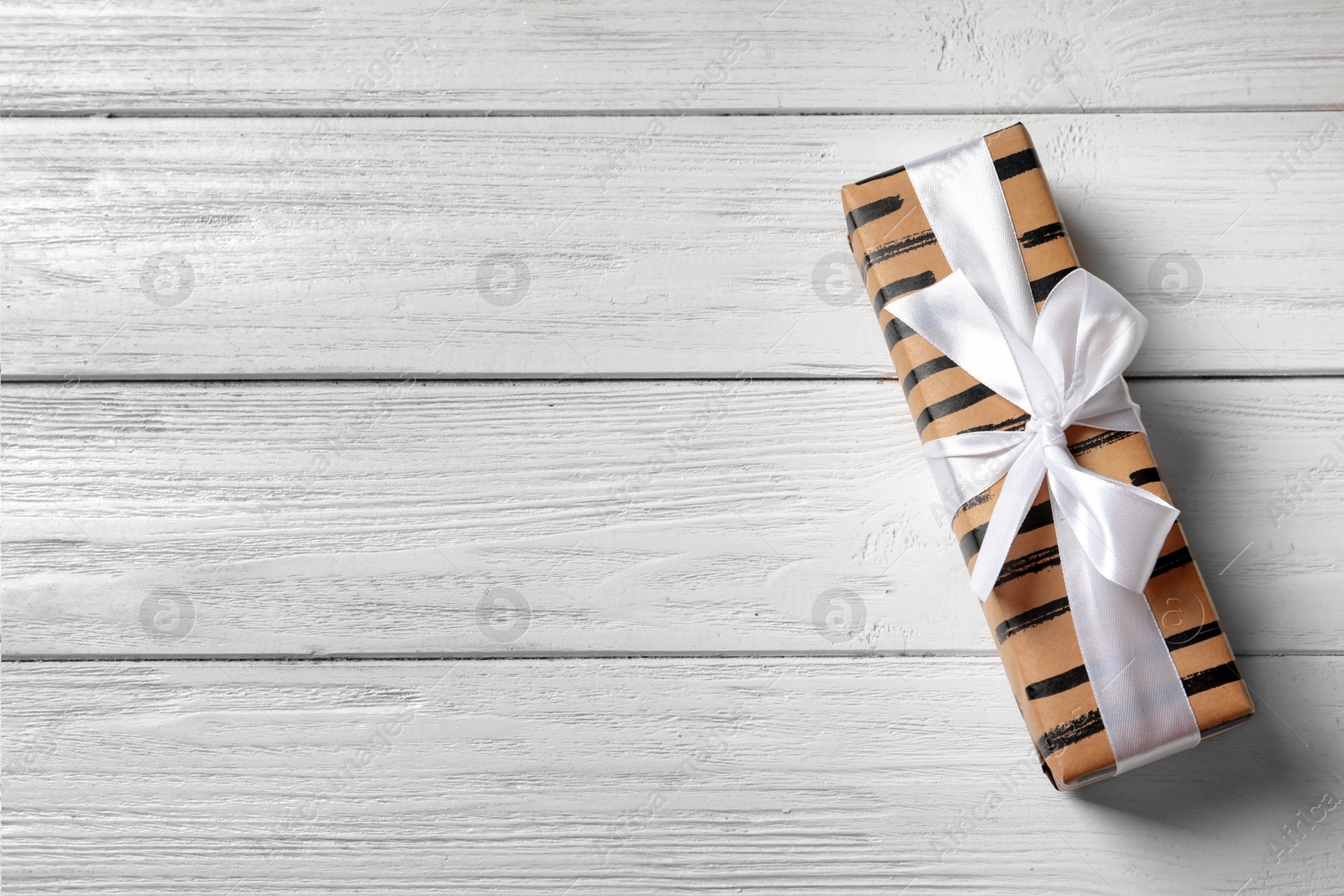 Photo of Beautiful gift box on wooden background, top view