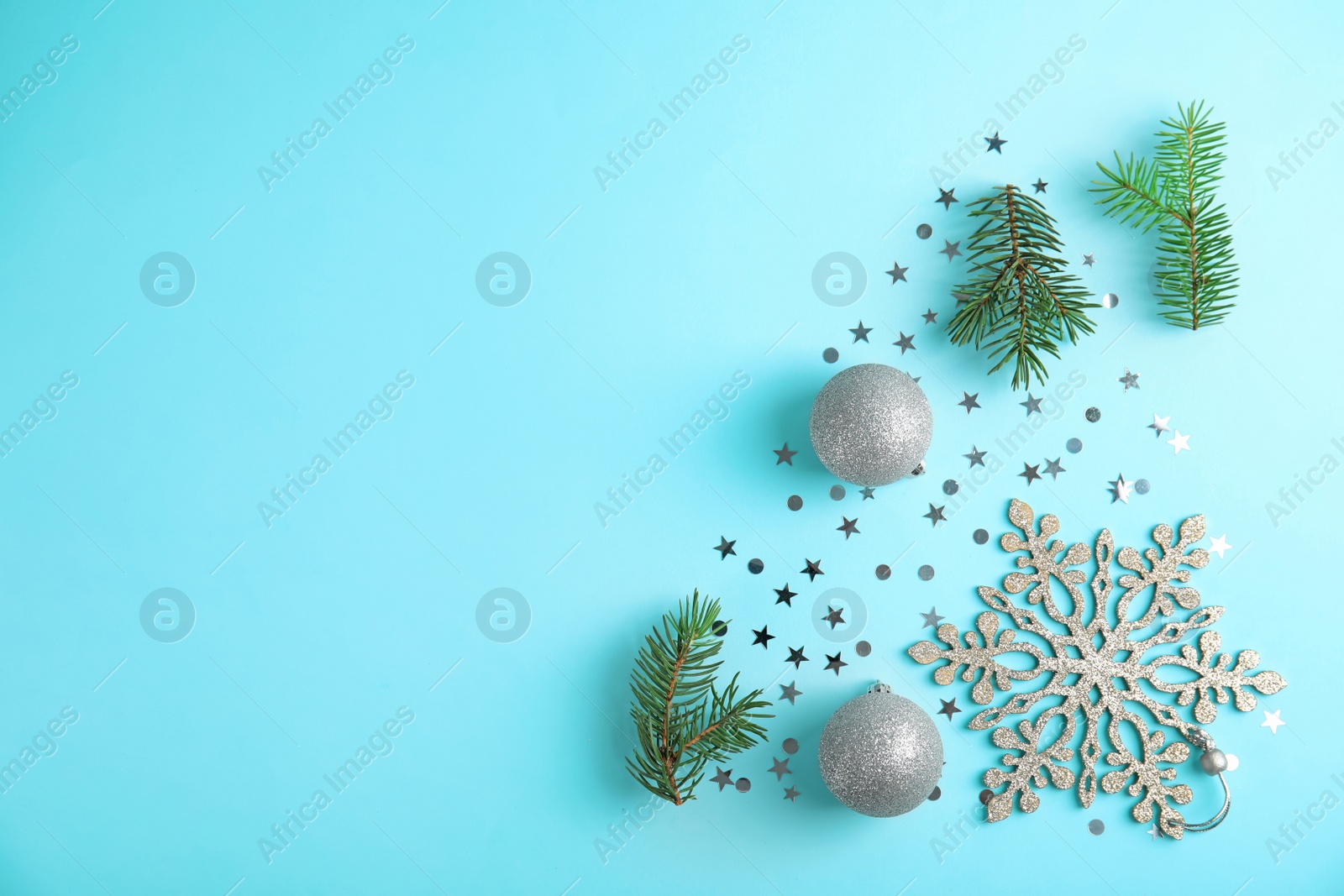 Photo of Flat lay composition with branches of Christmas tree on color background