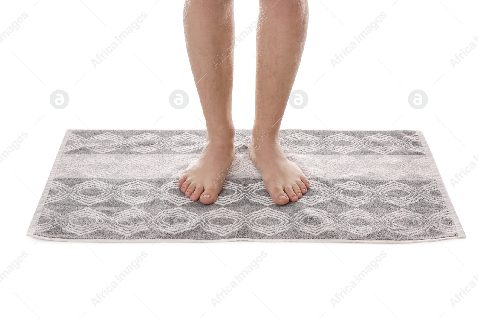 Photo of Man standing on stylish bath mat against white background, closeup