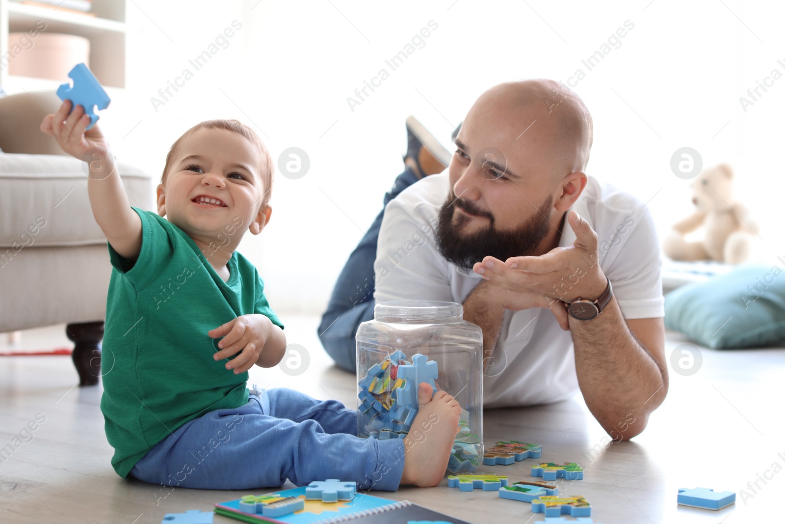 Photo of Dad and his little son playing together at home