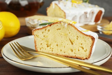 Piece of tasty lemon cake with glaze served on table, closeup