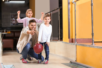 Happy family spending time together in bowling club