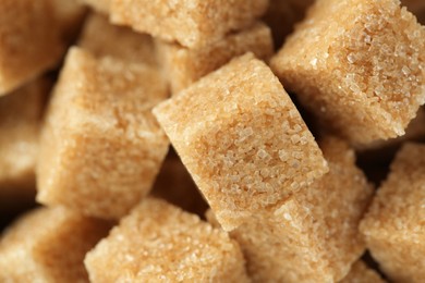 Photo of Brown sugar cubes as background, closeup view