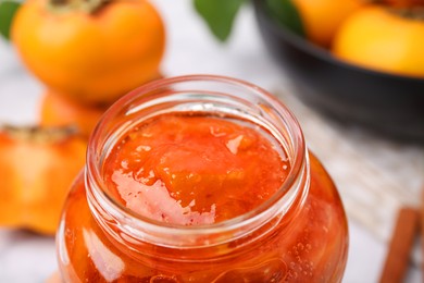 Jar of tasty persimmon jam, closeup view