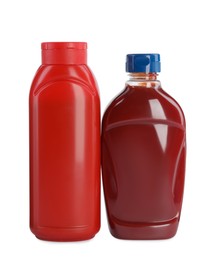 Different bottles of ketchup on white background