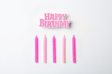 Flat lay composition with birthday candles on light background