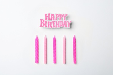 Photo of Flat lay composition with birthday candles on light background