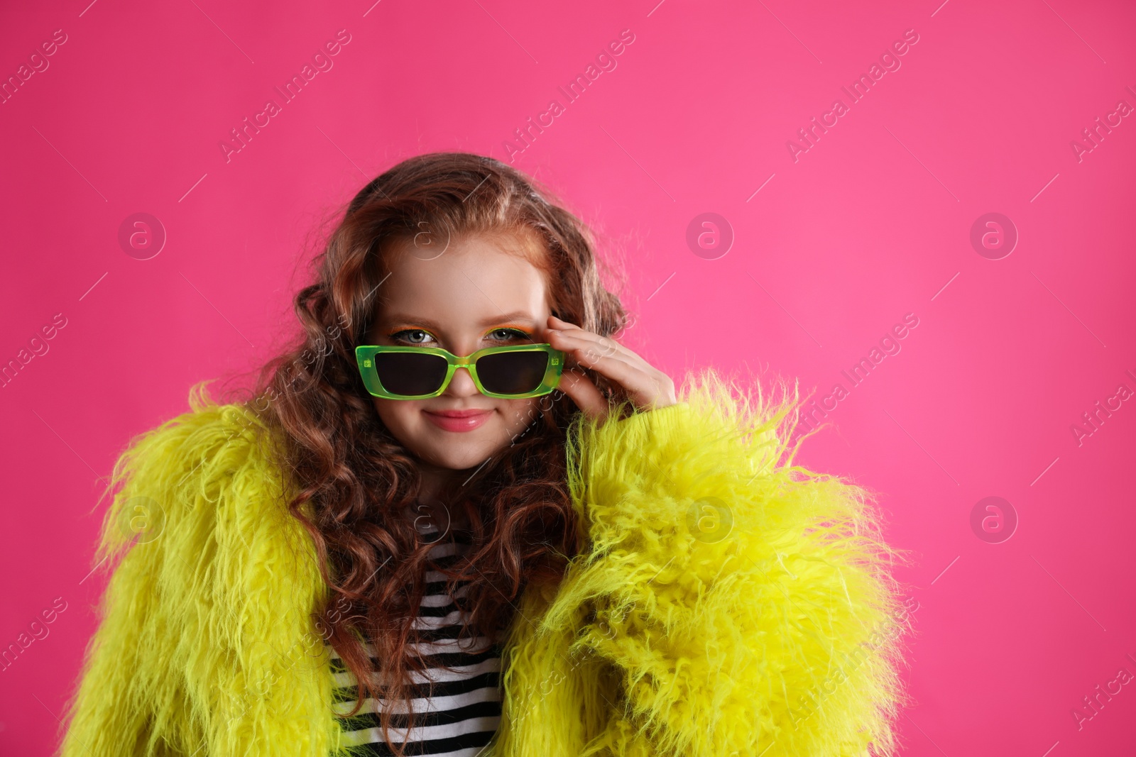 Photo of Cute indie girl with sunglasses on pink background, space for text