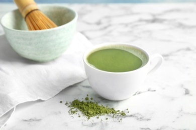 Cup of fresh matcha tea on table