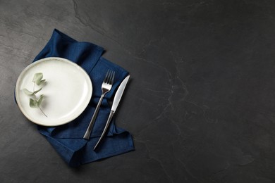 Photo of Stylish setting with elegant cutlery on grey textured table, top view. Space for text