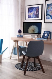 Photo of Modern workplace interior with computer on table