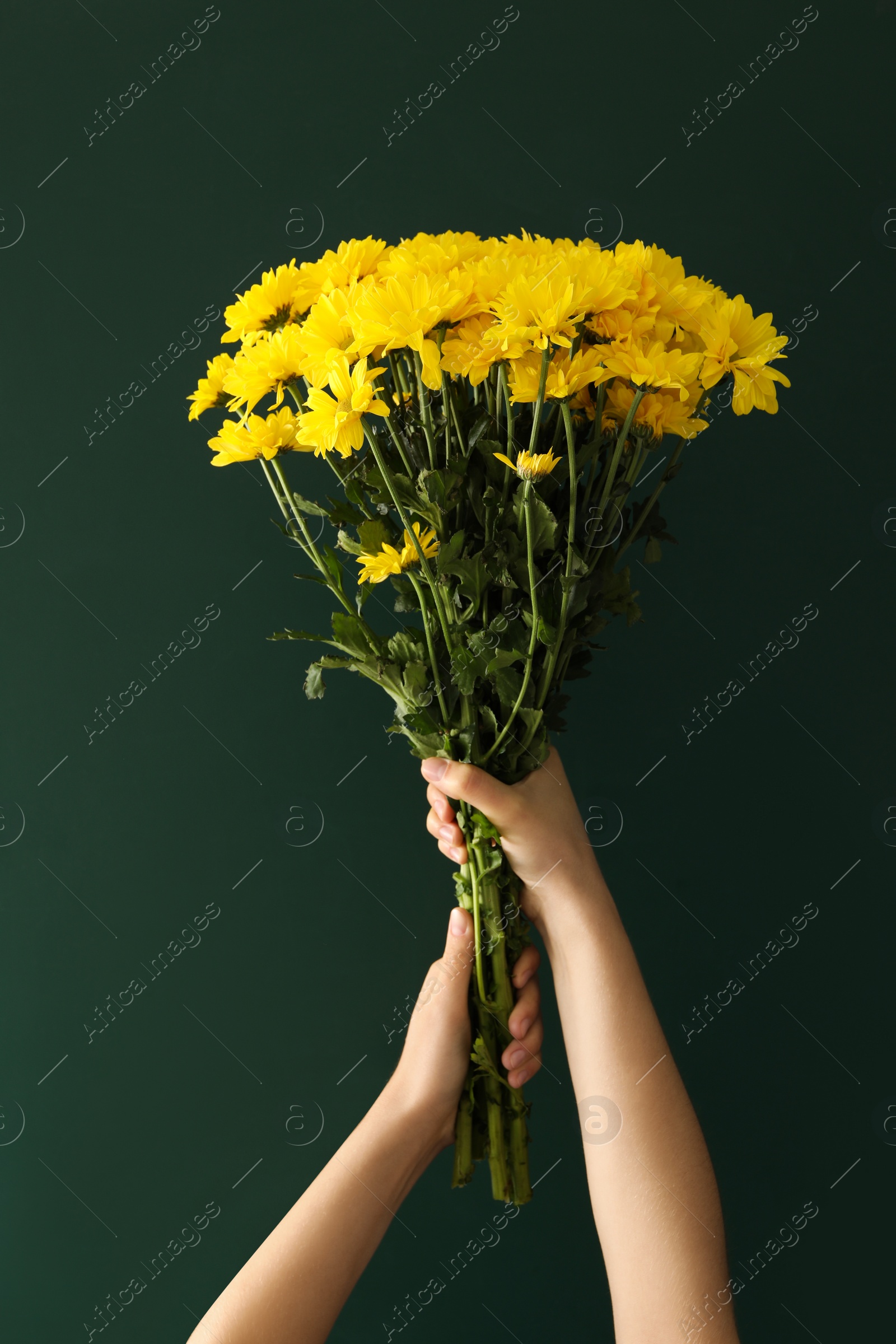 Photo of Woman holding beautiful bouquet near green chalkboard. Happy Teacher's Day