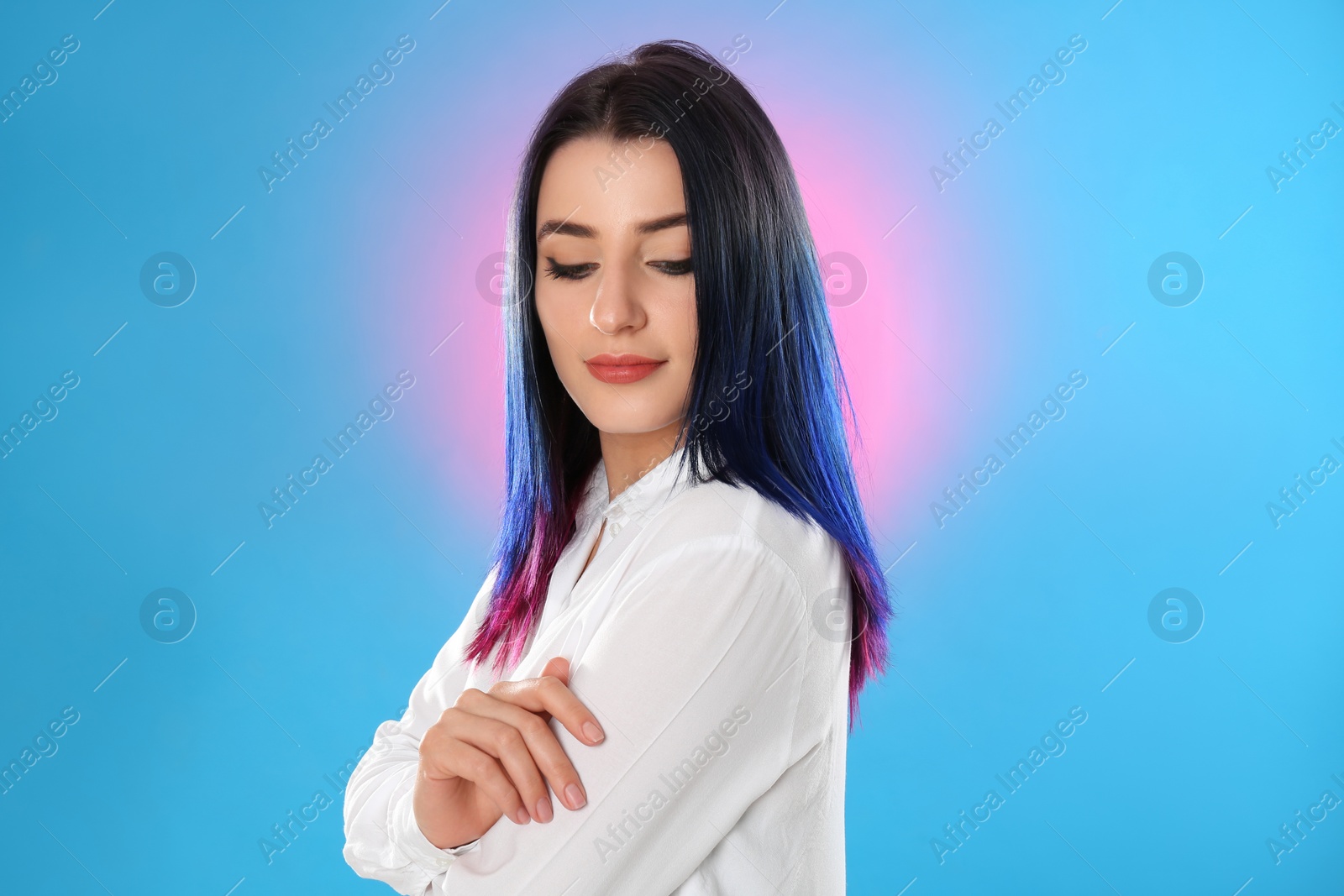 Photo of Young woman with bright dyed hair on color background