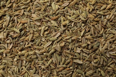 Photo of Many fennel seeds as background, top view