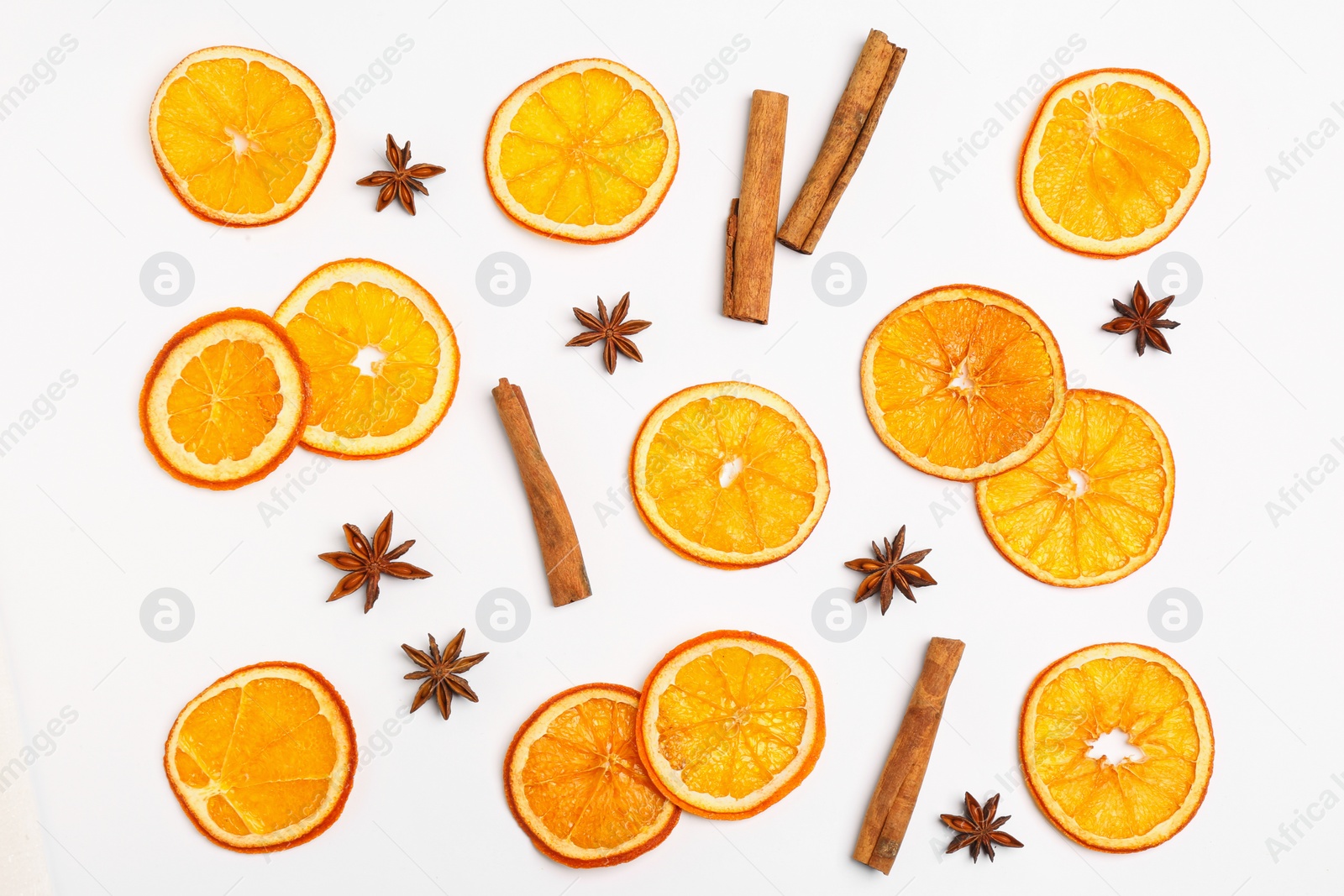 Photo of Flat lay composition with dry orange slices, anise stars and cinnamon sticks on white background