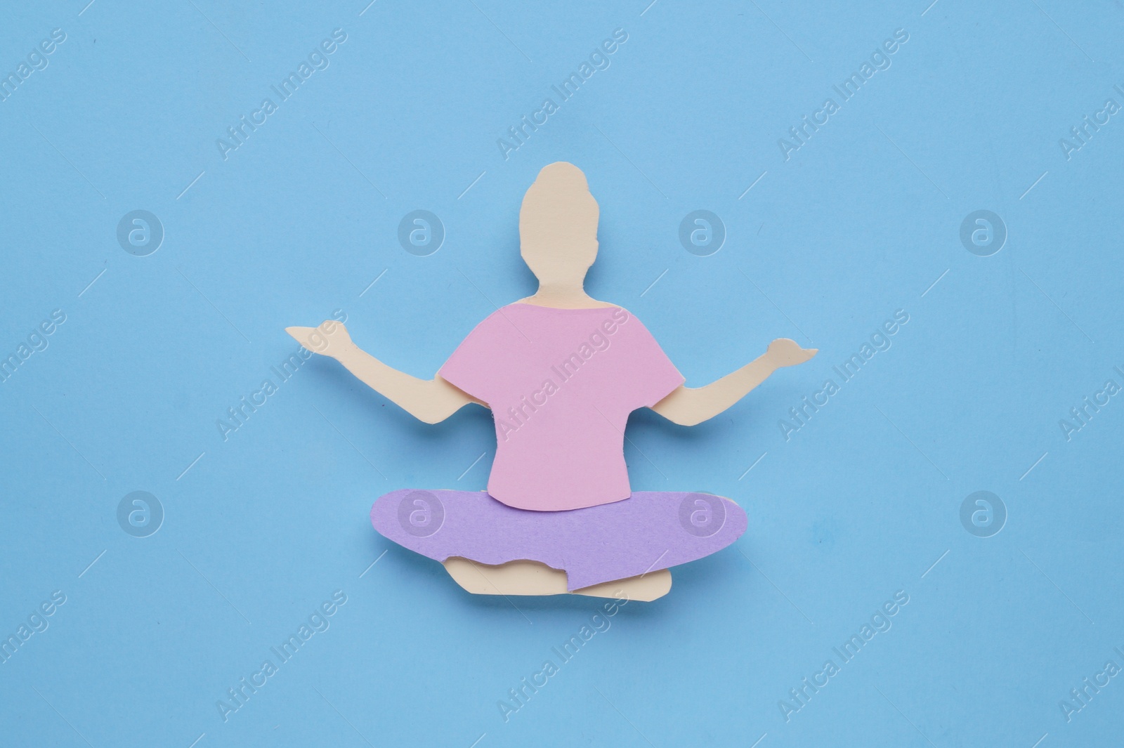 Photo of Woman`s health. Paper female figure on light blue background, top view